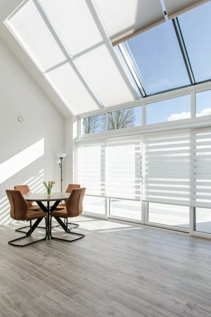 motorised cellular blinds on a glass roof open and closed with aura blinds below