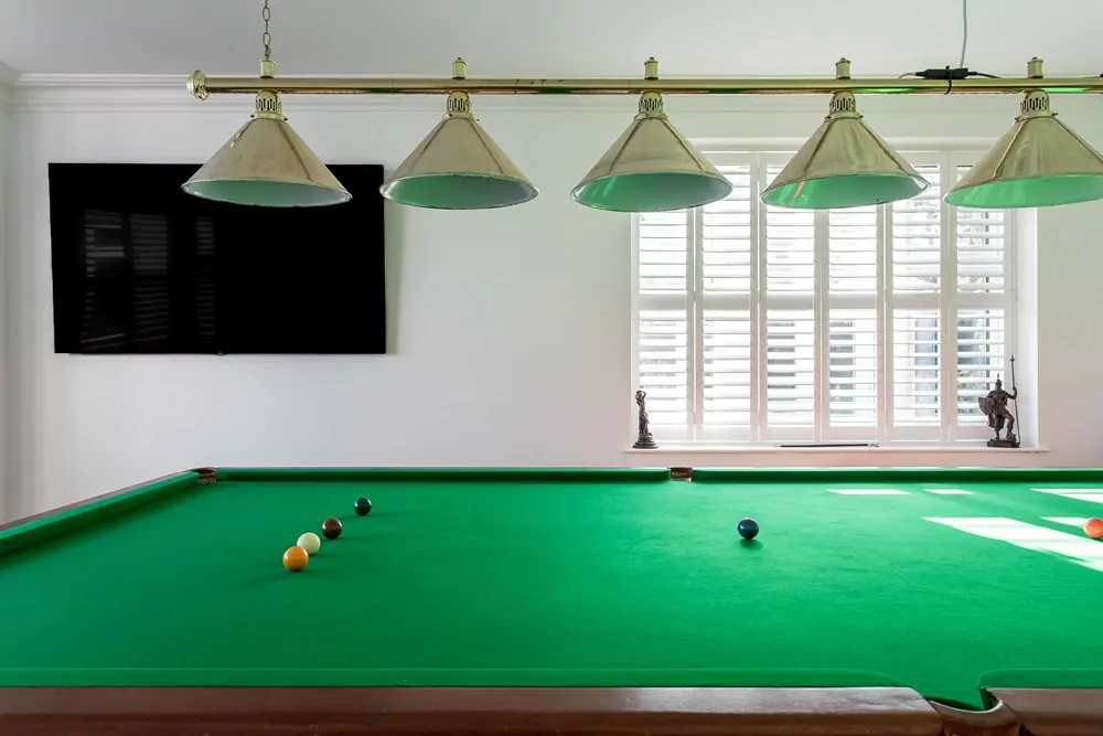 plantation shutters in window with pool table
