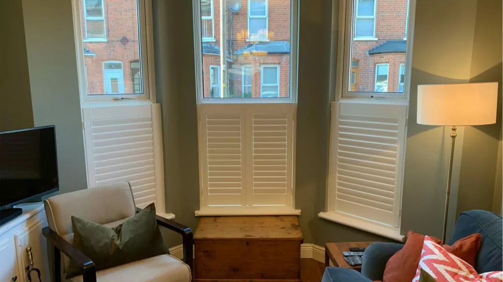 self build cafe style shutters in cozy living room creating privacy from the busy street in Northern Ireland