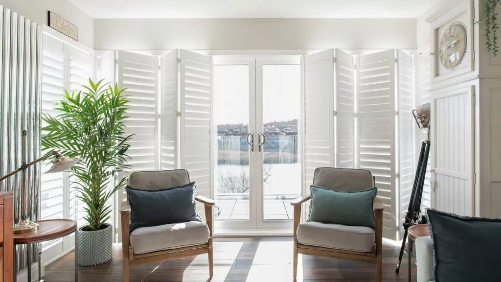 self build shutters in modern white room with view out to see in North coast of Northern Ireland