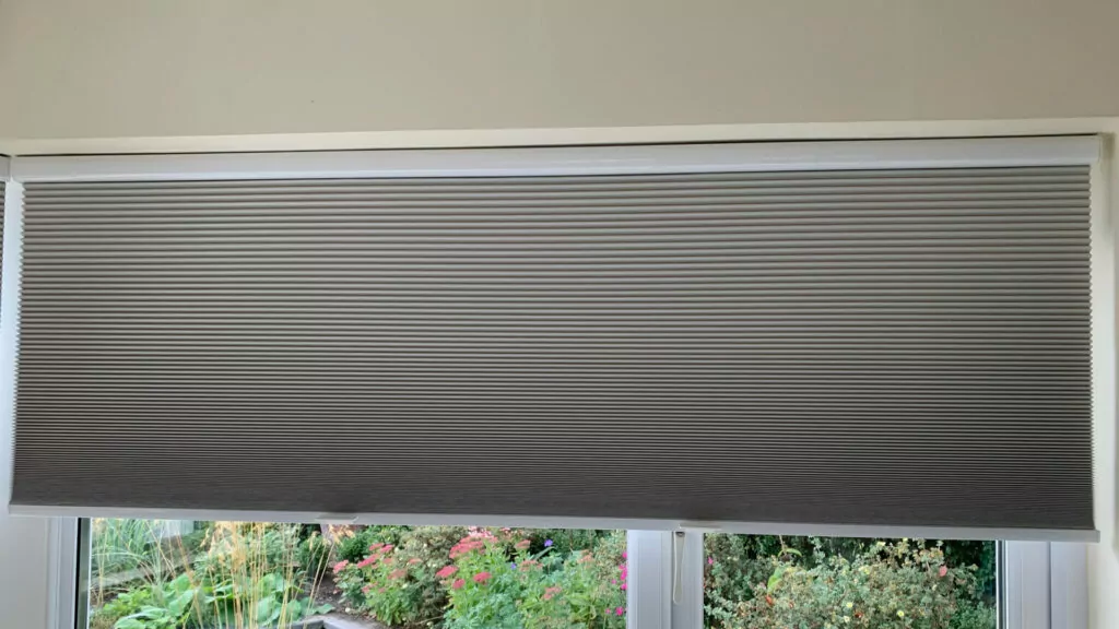 a thermal cellular blind using a blackout blind material to provide window insulation