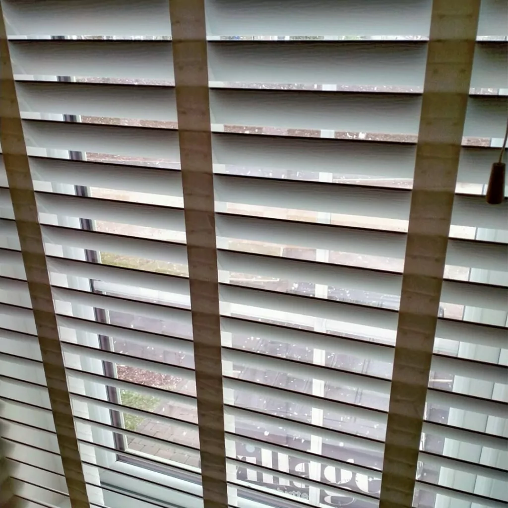 Upward closure of a white taped wooden blind in Northern Ireland