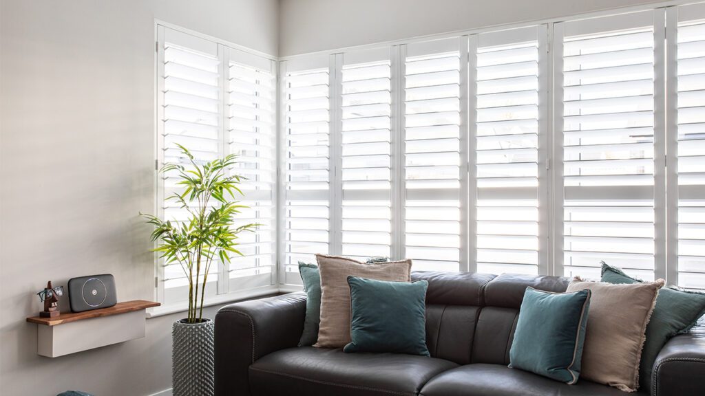 should all windows have shutters living room example in a modern contemporary home in northern ireland with white plantation shutters