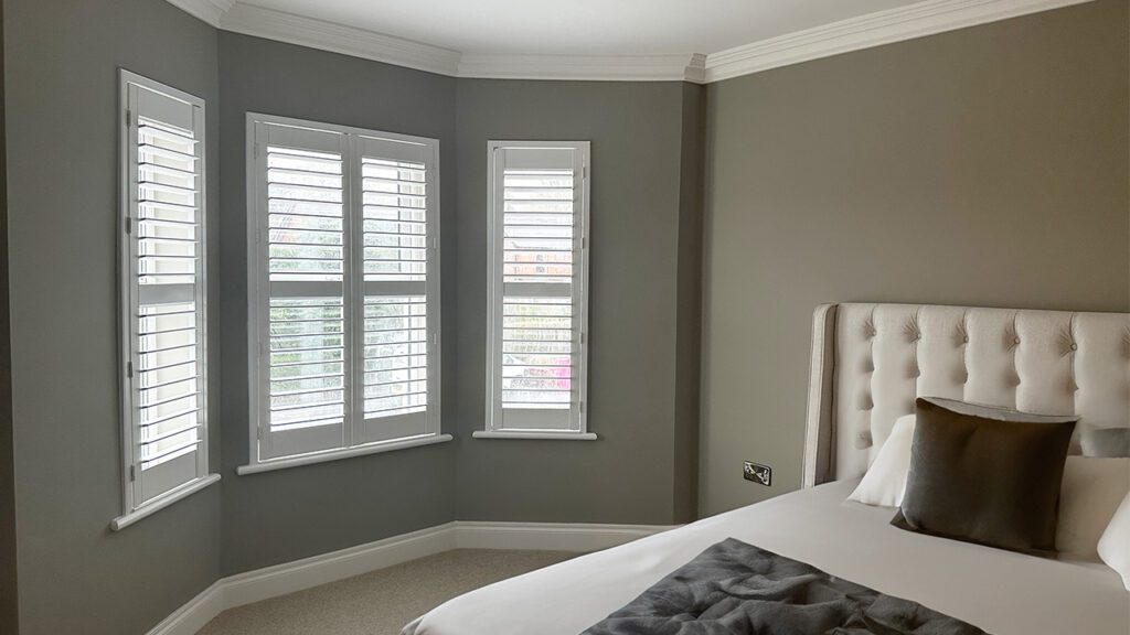 bedroom white plantation shutters in a contemporary townhouse in northern ireland